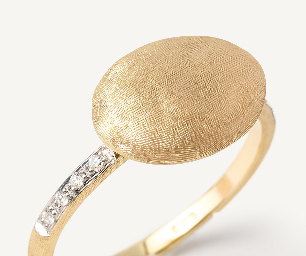 Ring with horizontal oval element and diamond shank